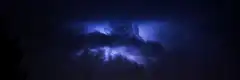 Dramatic blue lightning storm at night