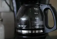 Mr. Coffee pot with dark liquid