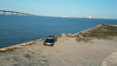 drone shot of car on concrete pier