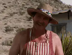 Man in apron and hat drinking beer