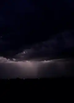 Lightning strikes in dark storm clouds