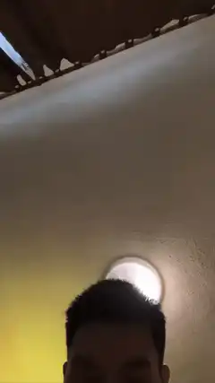 shirtless man selfie ceiling light