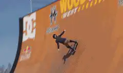Skateboarder flips off a large ramp