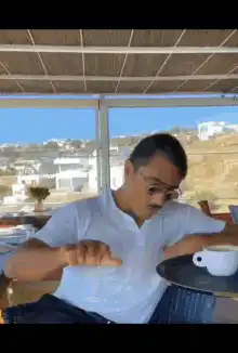 Man doing the coffee cup trick