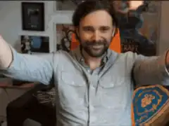 Man raises arms in victory then touches chest