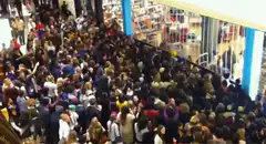 Crowd surging forward in a store