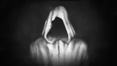hooded figure in dark