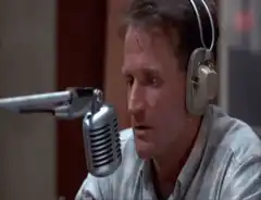 Robin Williams singing into a microphone