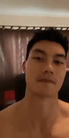 Shirtless man smirking at camera