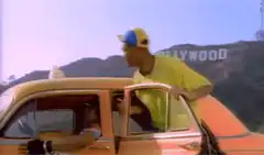 DJ Jazzy Jeff points at Hollywood sign