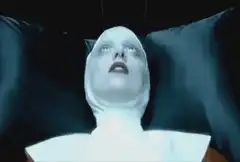 The Nun's face transforms and glows