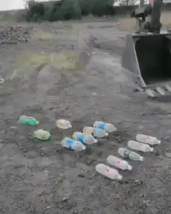 Excavator bucket scoops up plastic bottles