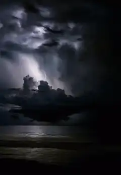 Lightning storm over ocean at night