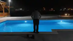 Man jumps into pool at night
