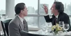 Two men talking at a restaurant table