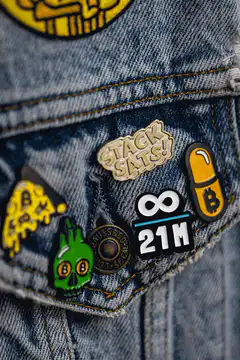 Bitcoin enamel pins on denim jacket