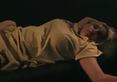 blonde woman lying in bed