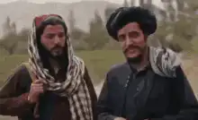 Two men laughing and waving