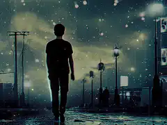 Man walking in the rain at night