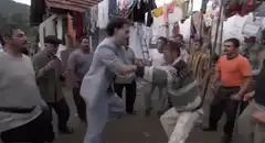 Two men dancing in a village street